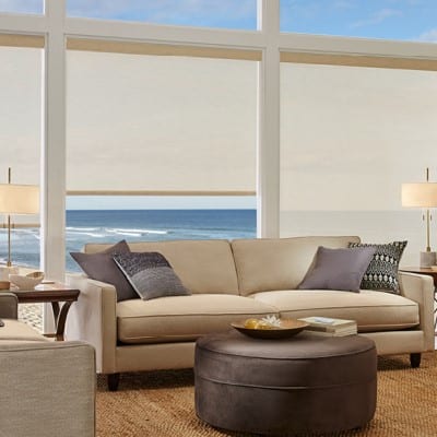 Living room with large white roller shades installed