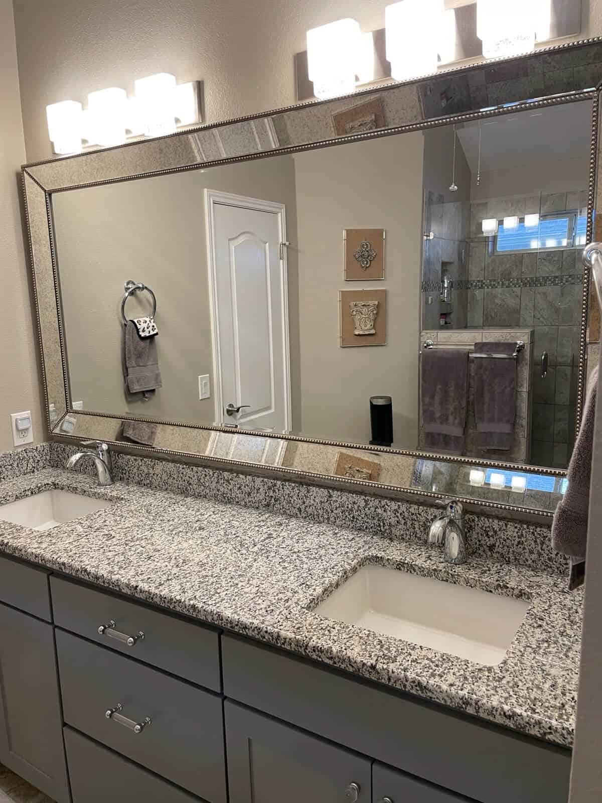 Large bathroom glass mirror installation by Shades of Texas