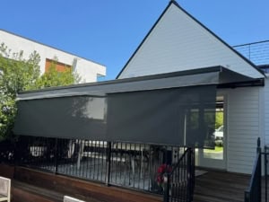 Outdoor awnings with drop shade installed on house by Shades of Texas.